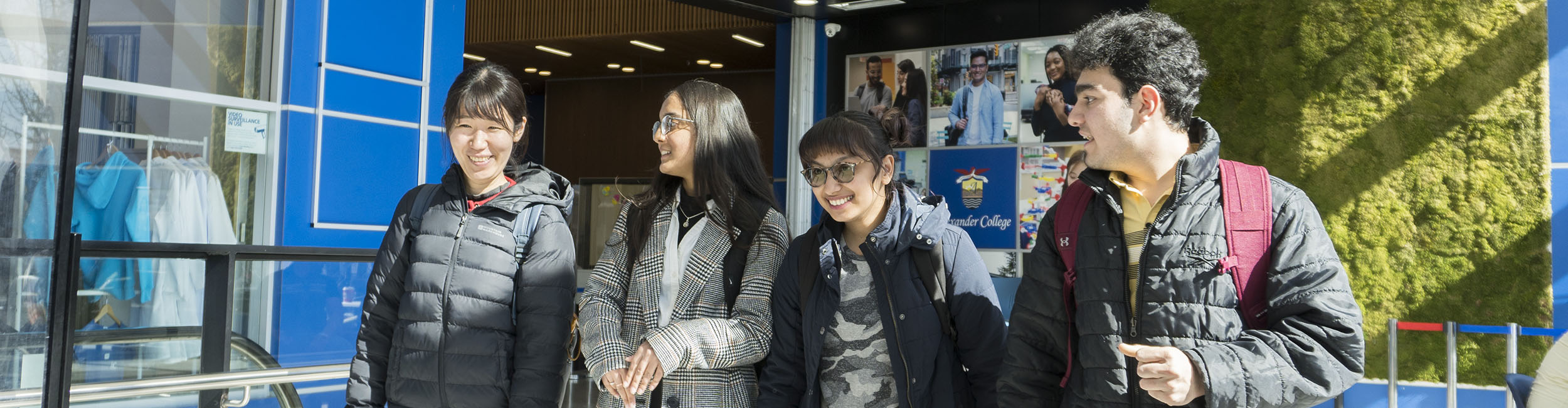 Three students in the student lobby at Alexander College Burnaby