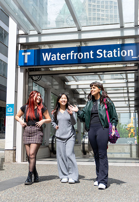 three students exiting the Canada Line Waterfront Station