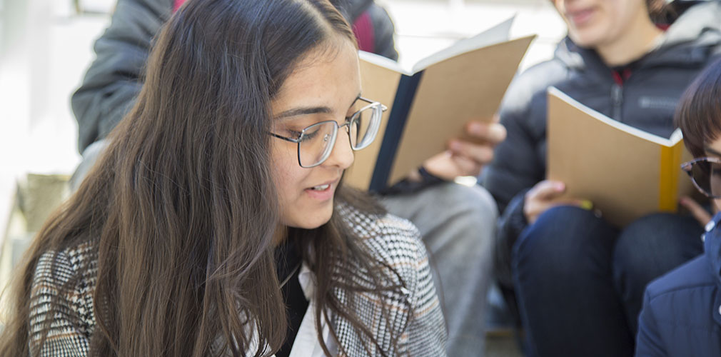 close-up of a student sitting with other students